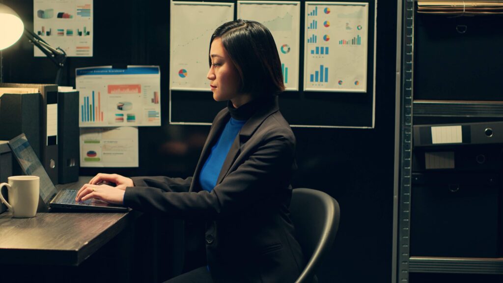 Tableau specialist working at her desk with laptops open.